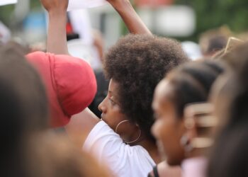 Many black people at a protest, not looking at the camera